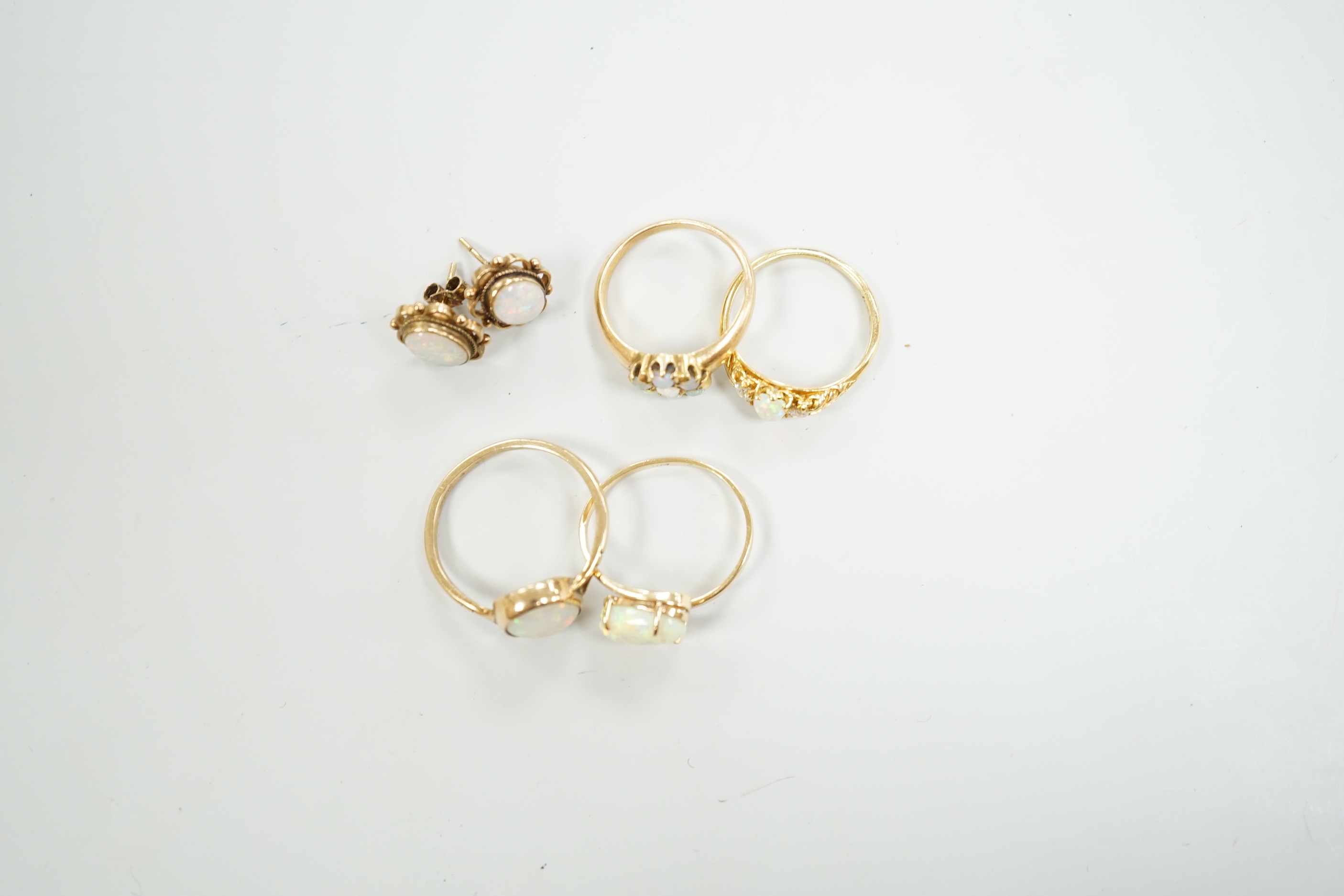 Two 18ct and white opal set rings, one with diamonds, gross 6.2 grams, a 14ct and white opal ring, a 9ct gold and white opal ring and a pair of 9ct gold and white opal earrings.